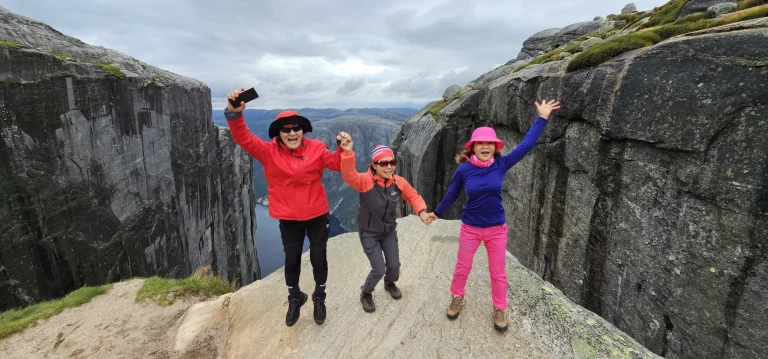 Guided hiking group at Kjeragbolten above Lysefjord in Norway