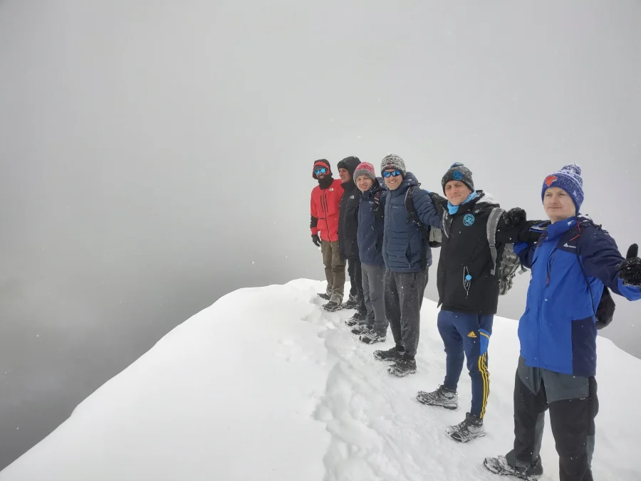 Group at the Pulpit Rock cliff in winter, Norway