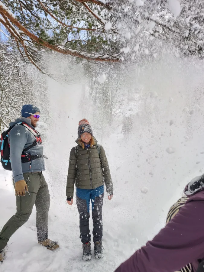 Guided winter hikers in snowfall on the Preikestolen trail, Norway