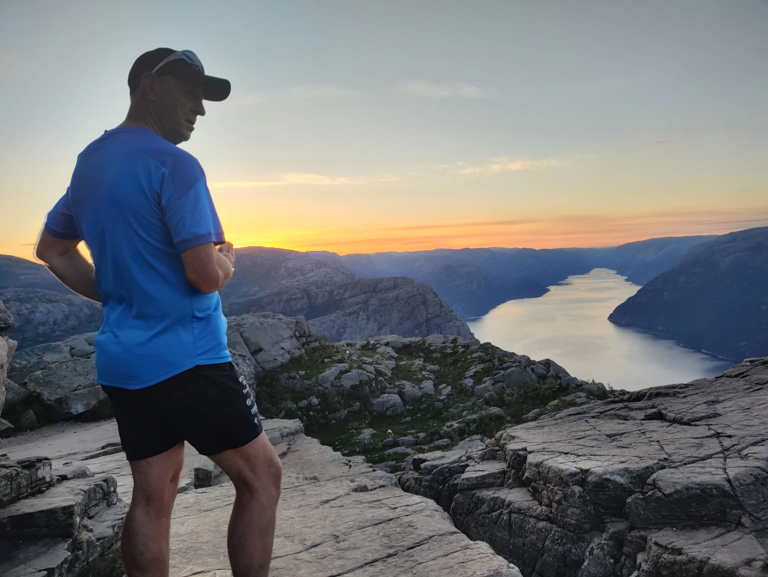 Trail runner on the route to Preikestolen above Lysefjord, Norway